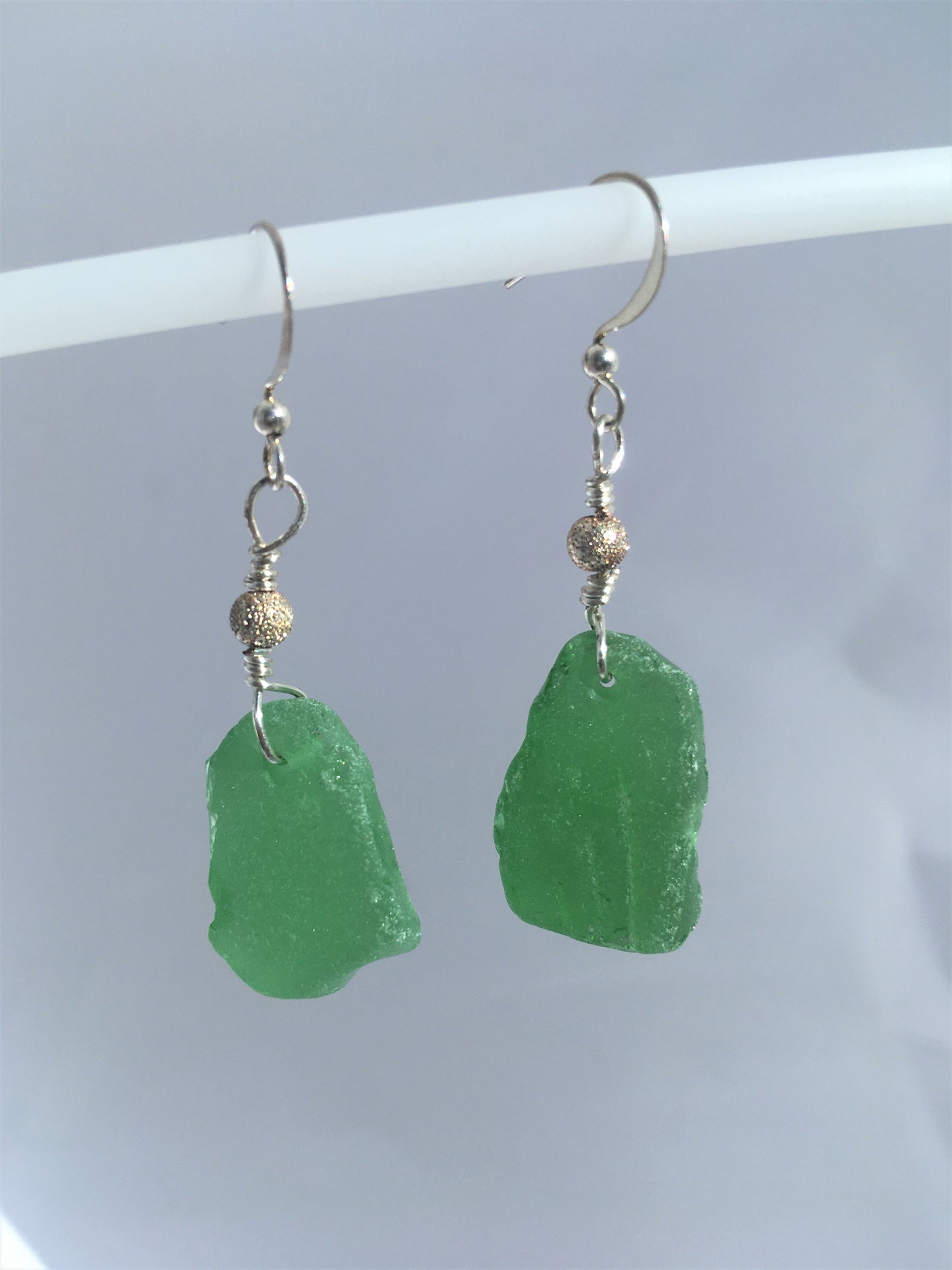 Stardust Earrings - Green sea glass from the South Shore, Nova Scotia, Canada with silver plated bead on a nickle-free hook