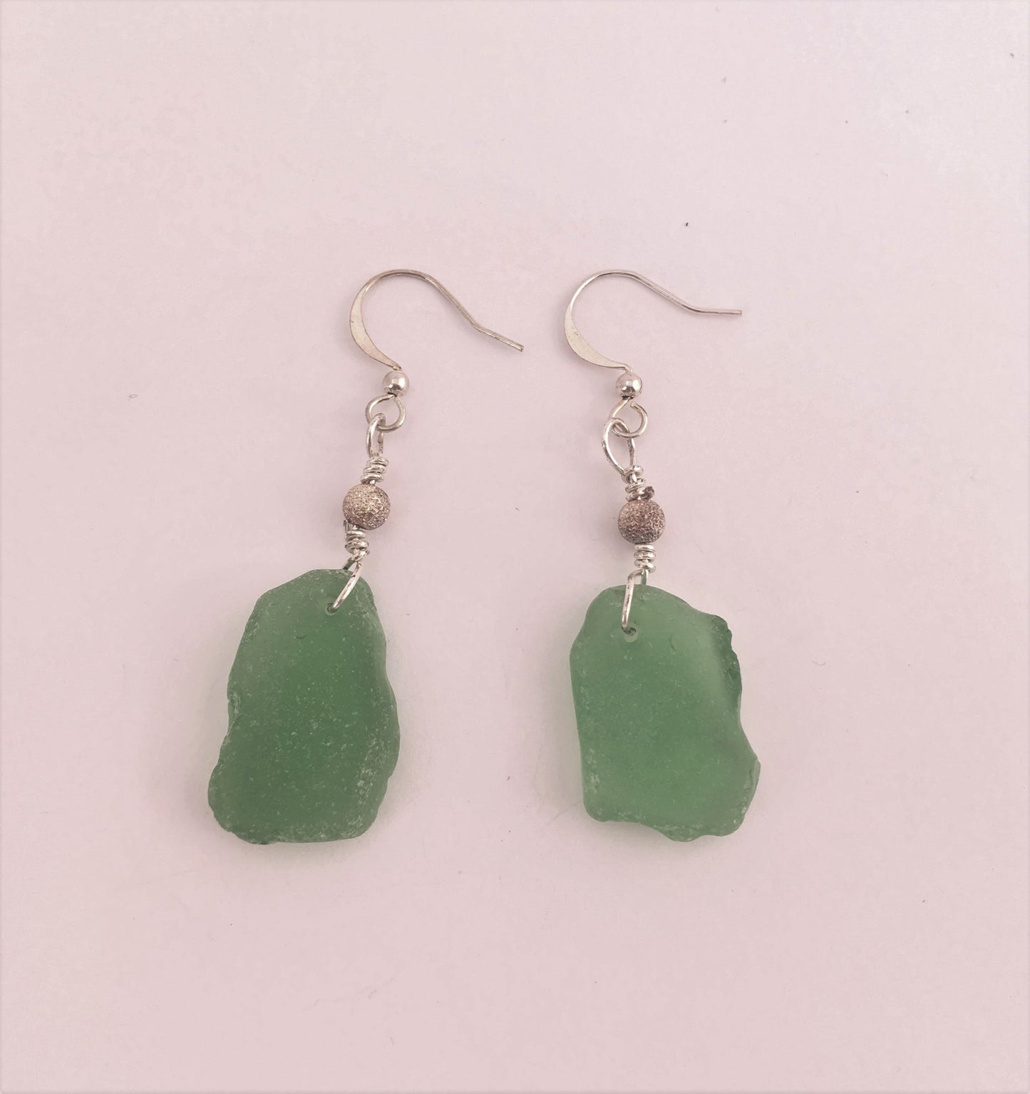 Stardust Earrings - Green sea glass from the South Shore, Nova Scotia, Canada with silver plated bead on a nickle-free hook