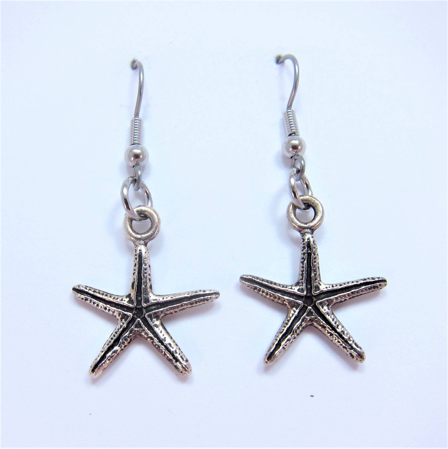 Charmed! Starfish / Sea star earrings silver plate antique finish on hypoallergenic surgical steel hooks