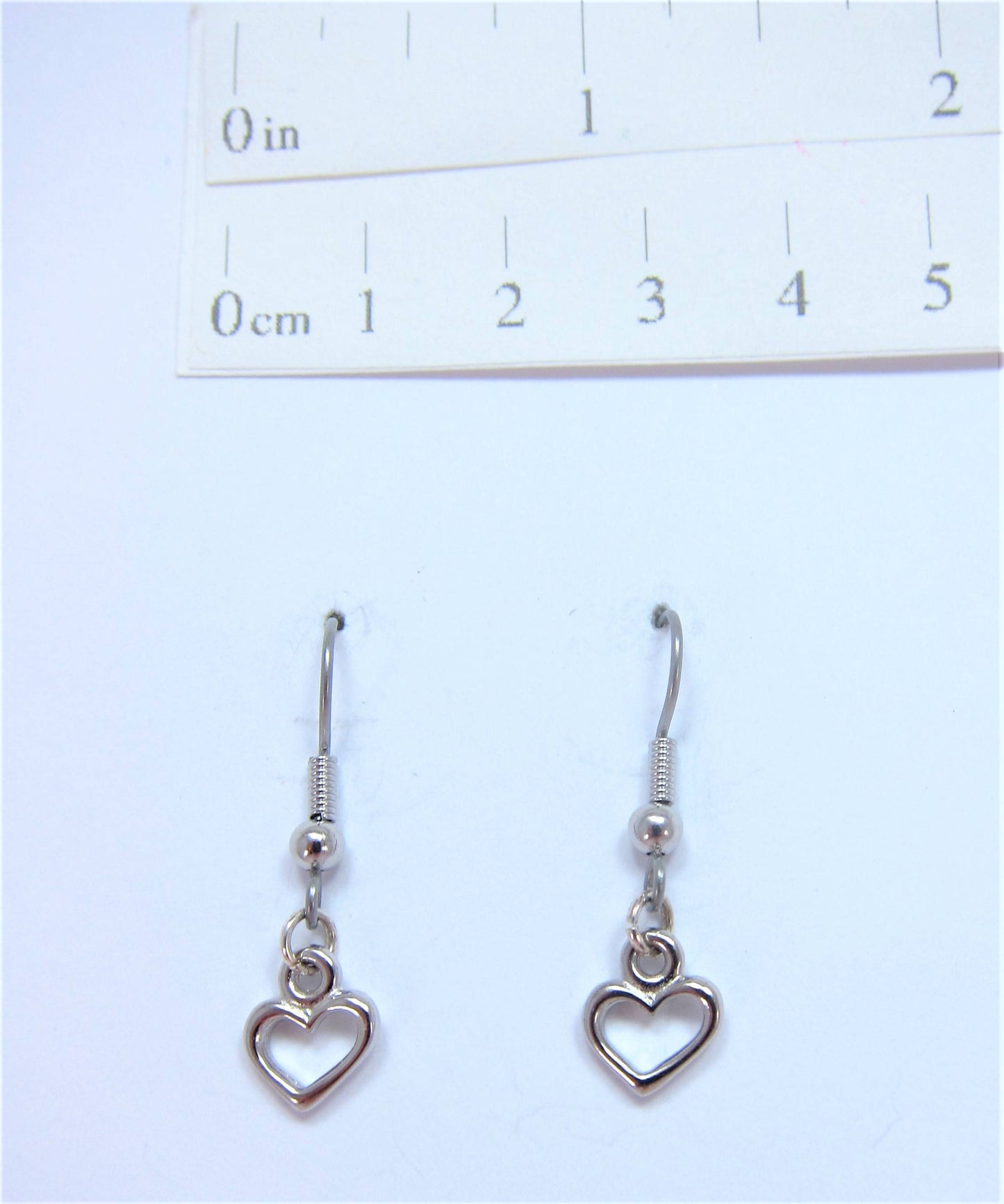 Charmed! Rhodium plate open heart earrings on hypoallergenic surgical steel hooks
